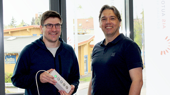 Two people smile into the camera