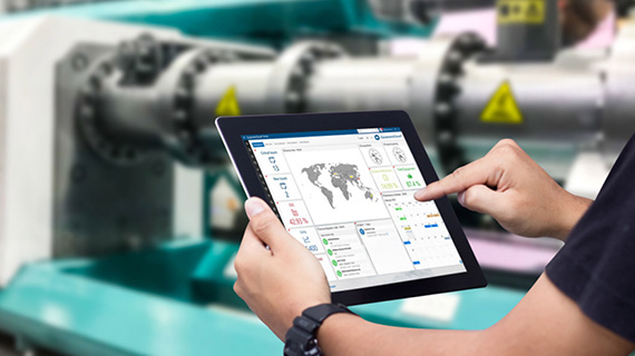 Person holding a tablet and operating the EquipmentCloud dashboard