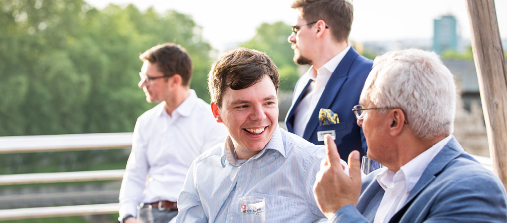 Two men talking at business event